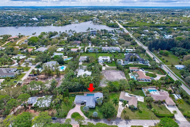 birds eye view of property with a water view and a residential view