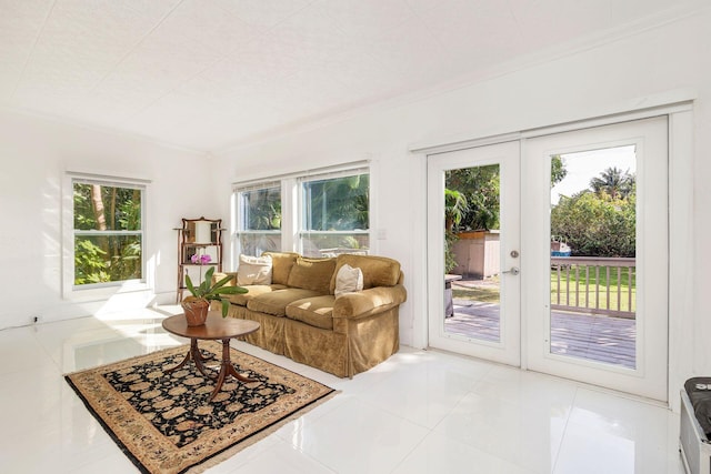 living room with a healthy amount of sunlight, crown molding, and light tile patterned floors