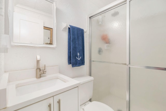 full bath with a shower with shower door, a textured wall, vanity, and toilet