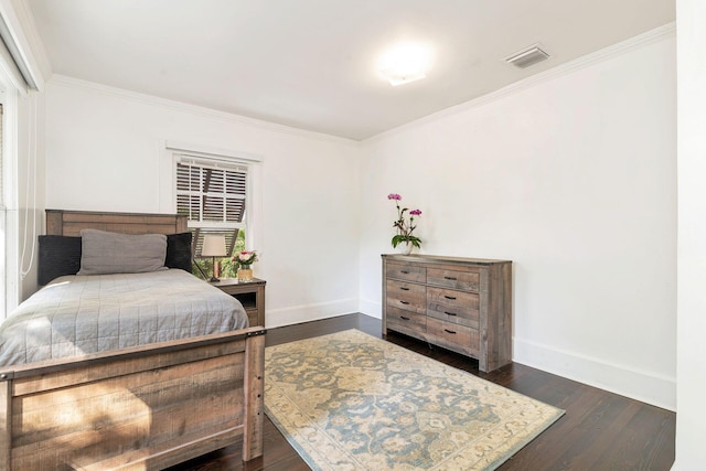 bedroom with baseboards, crown molding, visible vents, and dark wood-style flooring