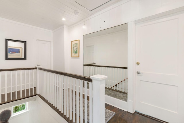 corridor with attic access, dark wood finished floors, ornamental molding, an upstairs landing, and recessed lighting