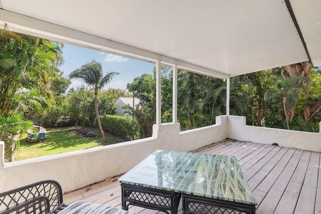 wooden terrace featuring a yard