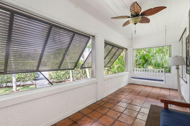 unfurnished sunroom featuring wooden ceiling and a ceiling fan