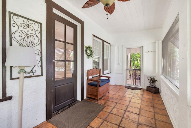 sunroom with wooden ceiling and a ceiling fan