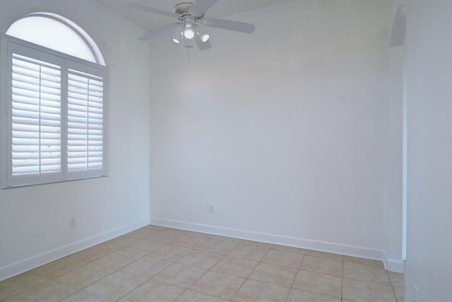 spare room with plenty of natural light, baseboards, and ceiling fan