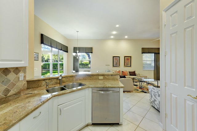 kitchen featuring decorative backsplash, dishwasher, light stone countertops, a sink, and light tile patterned flooring