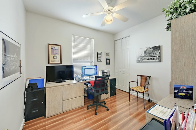 office with light wood-type flooring, baseboards, and a ceiling fan