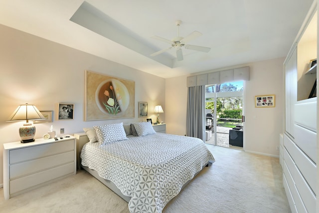 bedroom with ceiling fan, light colored carpet, baseboards, access to outside, and a raised ceiling