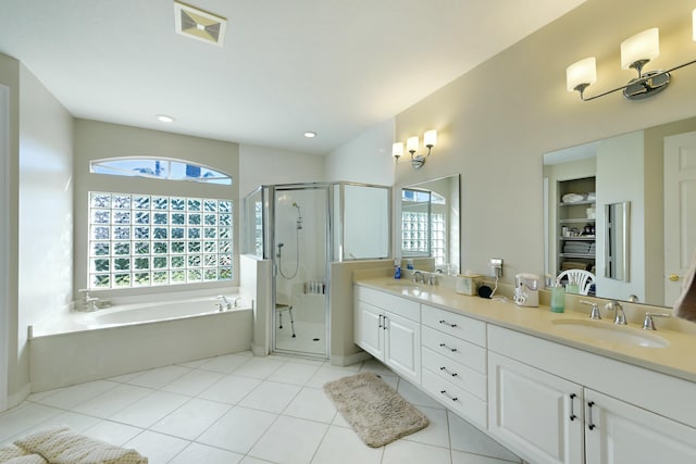 bathroom with a sink, visible vents, a bath, double vanity, and a stall shower