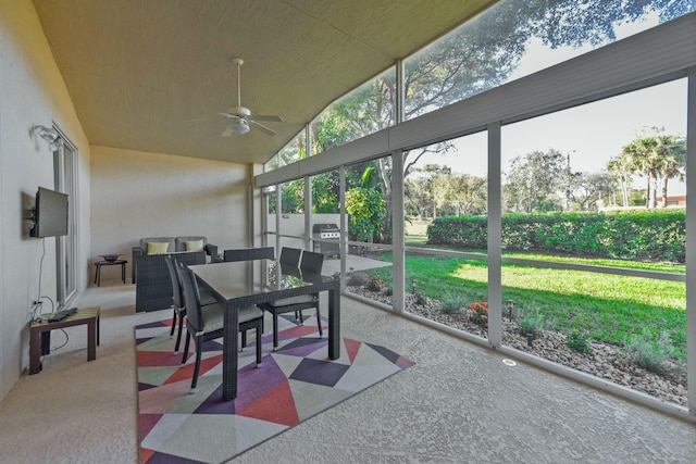 sunroom / solarium featuring vaulted ceiling and a ceiling fan