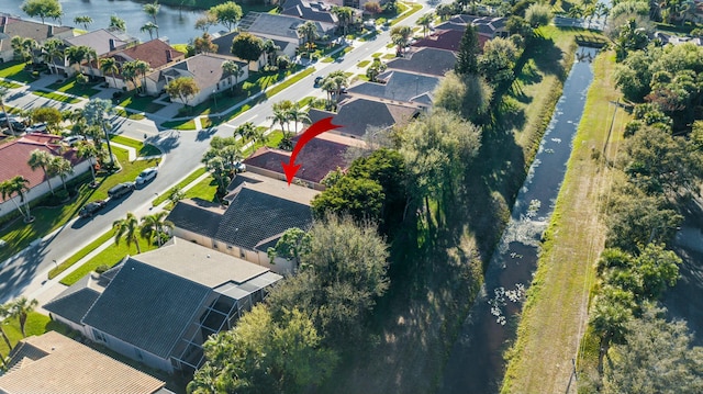 birds eye view of property with a water view and a residential view