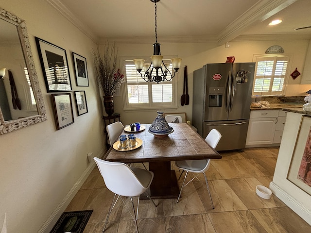 dining room featuring a chandelier, plenty of natural light, and ornamental molding