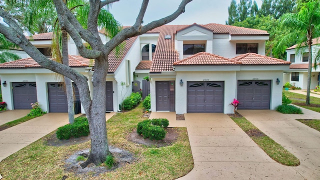 view of front facade with an attached garage and stucco siding