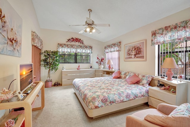 bedroom with light carpet, ceiling fan, and vaulted ceiling