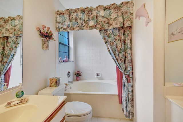 full bathroom with vanity, a garden tub, and toilet