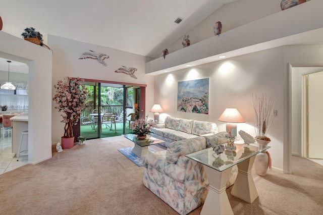 living room featuring baseboards, high vaulted ceiling, and light colored carpet