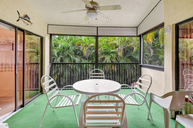 sunroom / solarium featuring ceiling fan