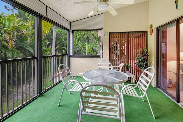 sunroom featuring vaulted ceiling and ceiling fan