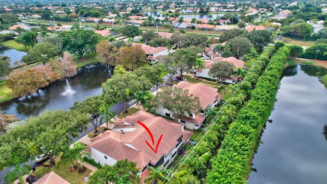 drone / aerial view with a water view and a residential view