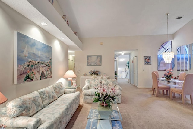 living room featuring a chandelier, light colored carpet, and visible vents