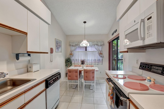 kitchen featuring white appliances, white cabinetry, light countertops, and decorative light fixtures