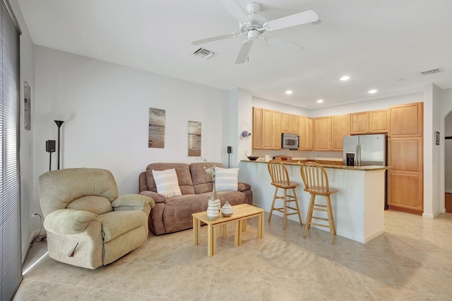 living area with a ceiling fan, recessed lighting, visible vents, and light tile patterned flooring