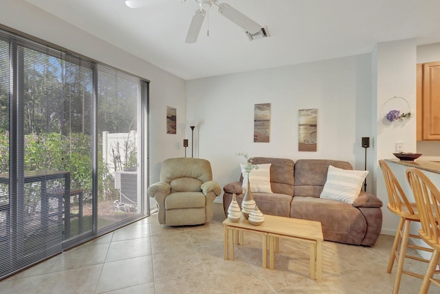 living room featuring light tile patterned floors, ceiling fan, and visible vents