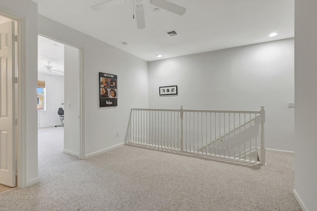 unfurnished room with baseboards, recessed lighting, visible vents, and light colored carpet