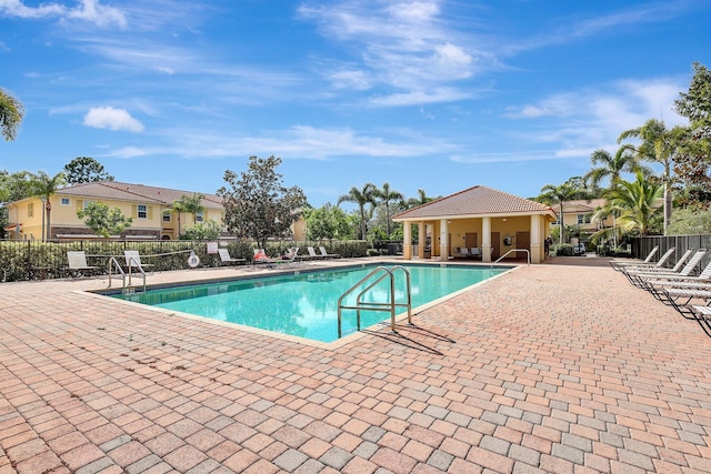 community pool featuring a patio area and fence