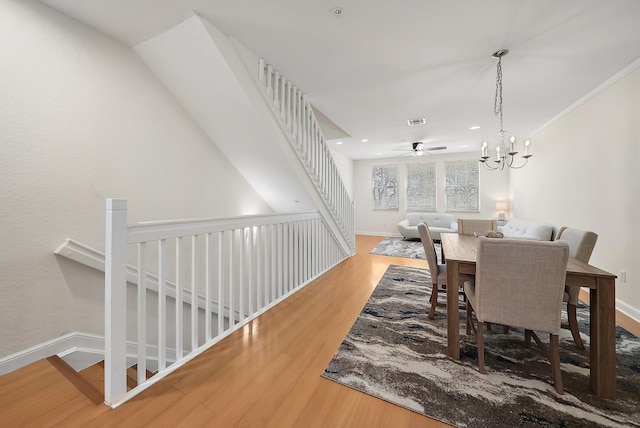 dining room with crown molding, recessed lighting, visible vents, wood finished floors, and baseboards