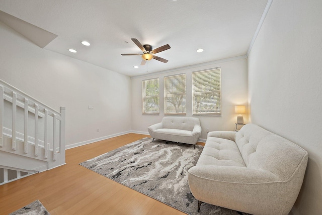 living area featuring recessed lighting, ceiling fan, baseboards, and wood finished floors