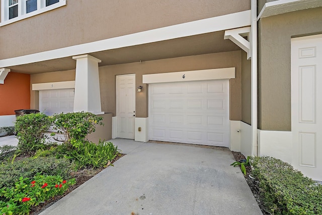 garage with concrete driveway