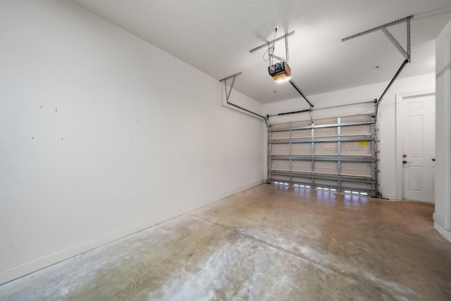 garage featuring baseboards and a garage door opener