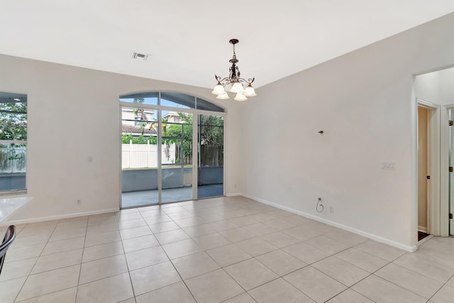 unfurnished room with baseboards, visible vents, a chandelier, and light tile patterned flooring