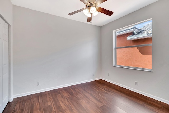 unfurnished room featuring ceiling fan, wood finished floors, and baseboards