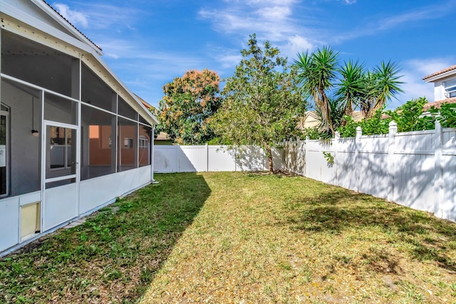 view of yard with a fenced backyard and a sunroom