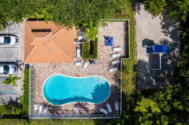 community pool featuring a patio area and fence