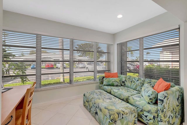 living room with light tile patterned floors, plenty of natural light, and baseboards