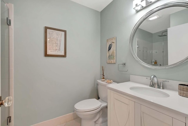 bathroom featuring toilet, tile patterned flooring, baseboards, and vanity