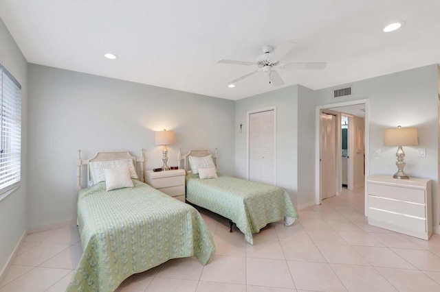 bedroom with light tile patterned floors, recessed lighting, a closet, visible vents, and baseboards