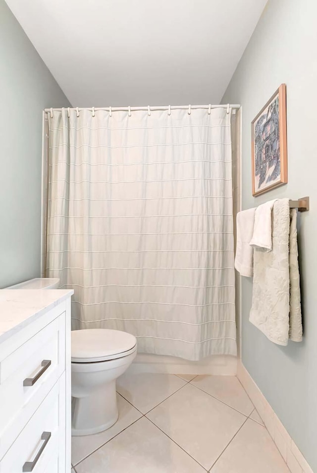 full bathroom with baseboards, vanity, toilet, and tile patterned floors