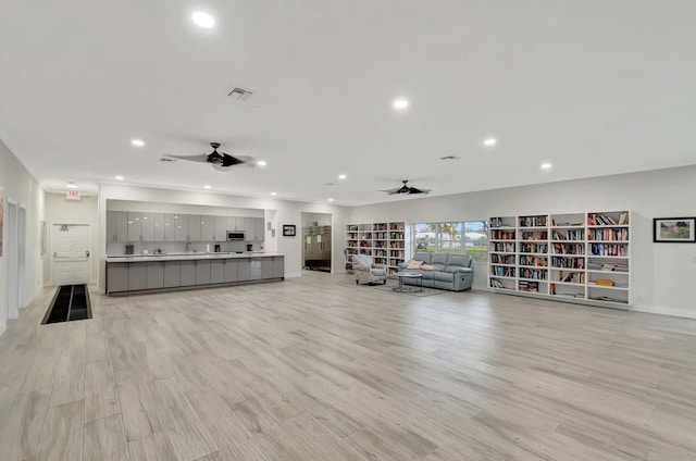 unfurnished living room with visible vents, light wood-style flooring, a ceiling fan, and recessed lighting