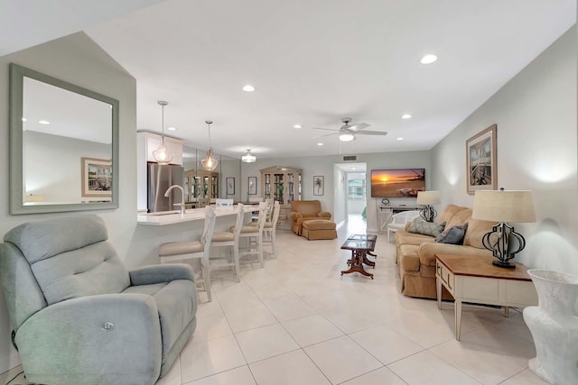 living area with a ceiling fan and recessed lighting