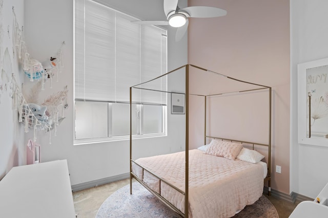 bedroom featuring ceiling fan, concrete floors, and baseboards