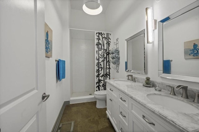 full bath featuring a sink, a shower stall, toilet, and double vanity