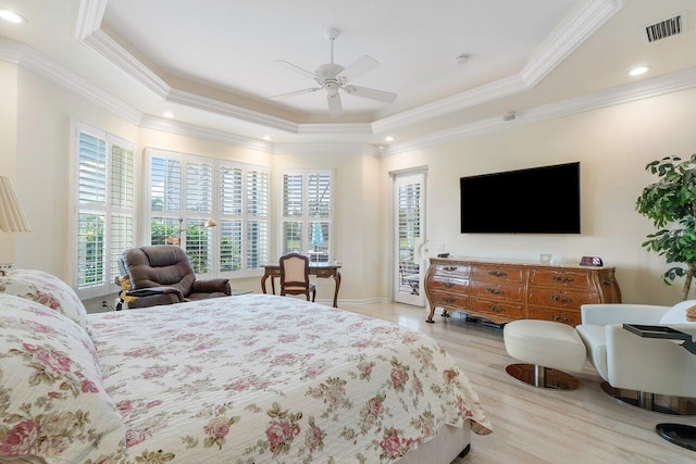 bedroom featuring light wood finished floors, visible vents, access to outside, a tray ceiling, and crown molding