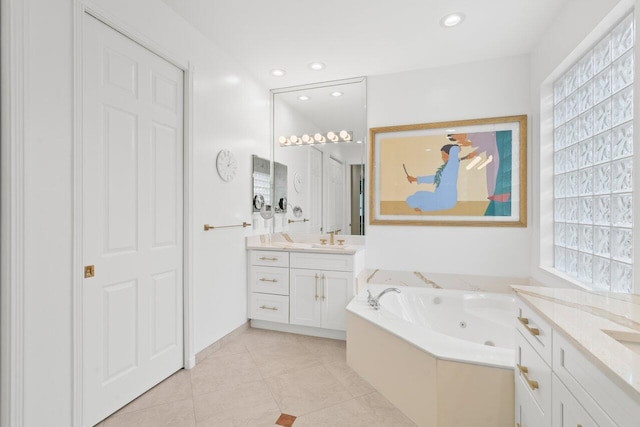 bathroom with tile patterned floors, a jetted tub, a sink, two vanities, and recessed lighting