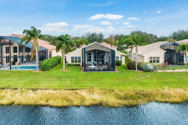 rear view of property featuring glass enclosure, a water view, an outdoor pool, a yard, and stucco siding