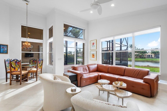 living room featuring ornamental molding, ceiling fan with notable chandelier, a water view, and light tile patterned flooring