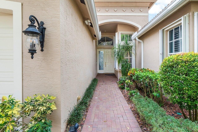 entrance to property featuring stucco siding